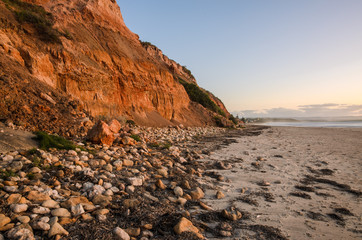 Cliffs coast line sand beach landscape at sunset