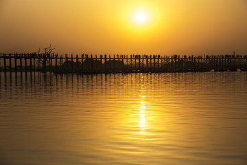 Fototapeta na wymiar Silhouetted people on U Bein Bridge at sunset, Amarapura, Mandal