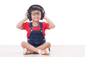 Little boy with headphones on the head listening to the music 