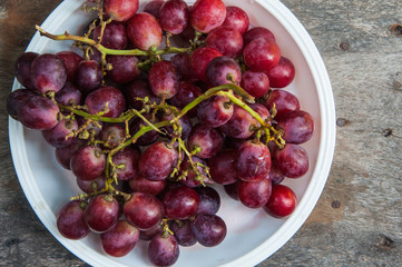 Bunch of red grapes on wooden table