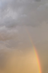 Obraz premium colorful rainbow on rain cloud sunset sky