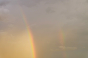 colorful rainbow on rain cloud sunset sky