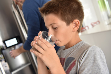 Young boy drinking fresh water