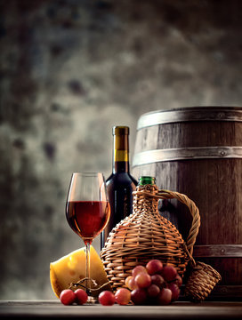 Glass, bottle, carafe of wine and barrel