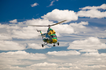 Fototapeta na wymiar Flying military helicopter in sky background