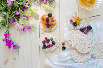 Obraz na płótnie Canvas Rice cakes with jam and berries for breakfast