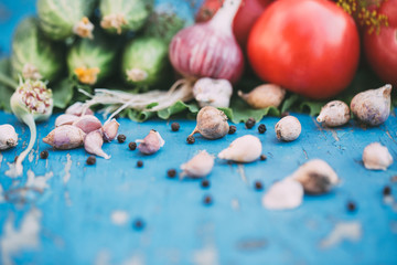 Fresh vegetables on natural wooden blue background.