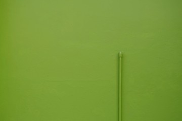Pipe on green wall