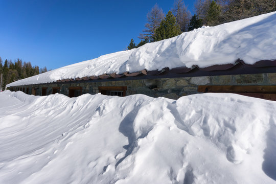 House Covered And Buried By Snow