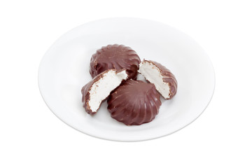Zefir glazed by chocolate on a white dish