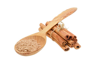 Cinnamon sticks and cinnamon powder on a light background