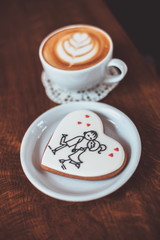cup of hot cup of coffee on the table, latte art with cookies