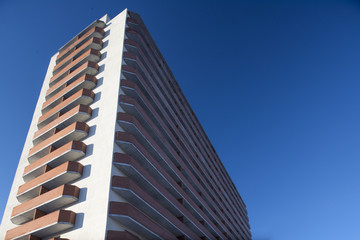 Obraz premium high residential building on a background of blue sky with tilt-shift effect 