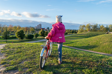 The girl in the red jacket with the bike