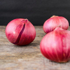 fresh red onions on a wooden background