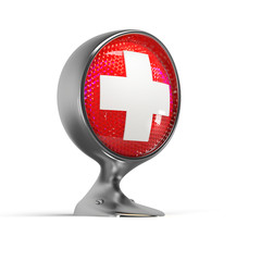 illuminated first aid sign on a vintage headlight