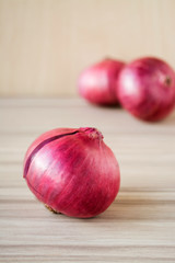 Red Onion on old wooden background