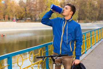 Male cyclist stopping for a drink