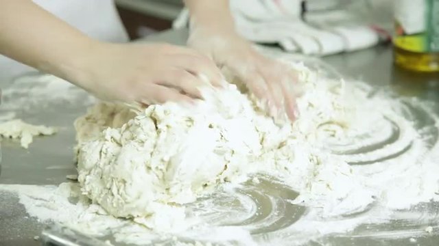 Woman preparing  pizza dought