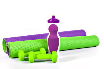mat workouts. Yoga mat in a roll.  Two dumbbells.