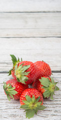 Strawberry fruit over wooden background