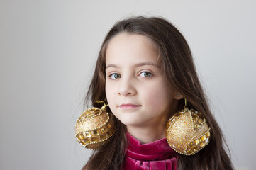 girl with New Year's toys spheres on ears © ruslanshug