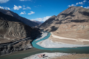 The icy waters of the Zanskar River merge with the Indus River in the Ladakh region of the...