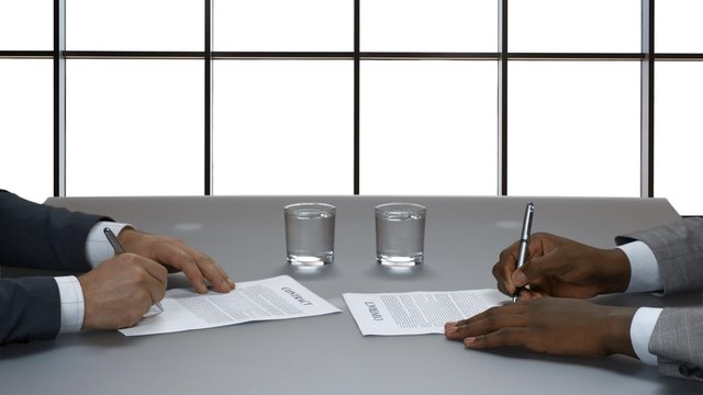Businessman signs a contract.