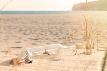Fototapeta na wymiar Message in a Bottle on the beach 