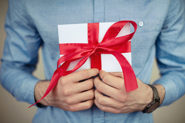 man holding letter with ribbon