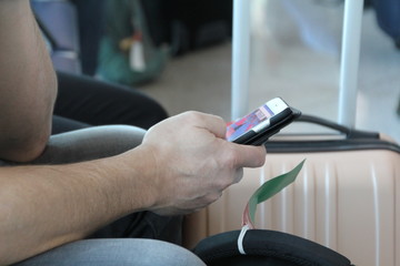 man traveling and checking a smartphone