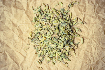 Heap of fennel dill seeds on paper surface