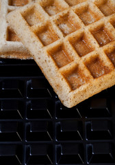 Traditional belgium soft waffles on background of baking dish