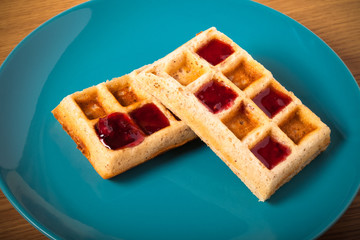 Traditional belgium soft fresh waffles with a decor on a plate.