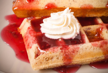 Traditional belgium soft fresh waffles with a decor on a plate.