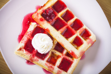 Traditional belgium soft fresh waffles with a decor on a plate.