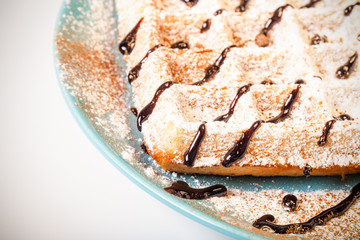 Traditional belgium soft fresh waffles with a decor on a plate.