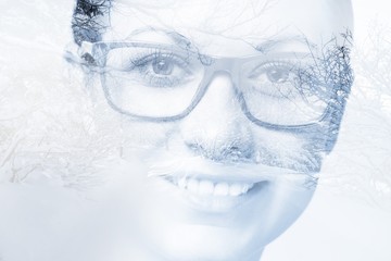 Unusual face of a woman in the forest, double exposure digitally modified