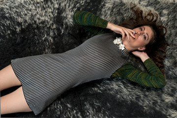 young woman smokes lying in the carpet