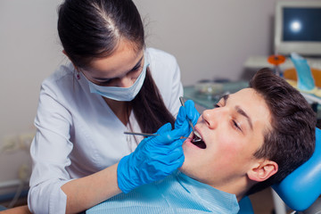 Fototapeta premium Man having teeth examined at dentists dental treatment