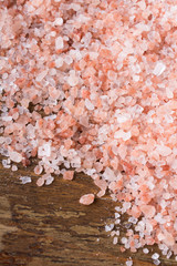 Closeup of a Himalayan salt on wooden background - shallow depth of field