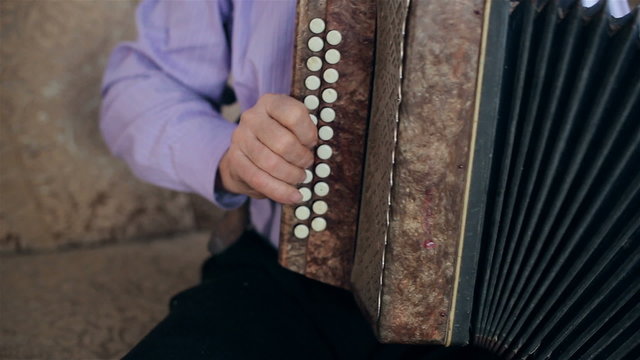 An old man playing the harmonica