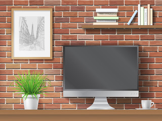 Work table, computer and shelves with books on brick wall background. Workplace in the office or at home.