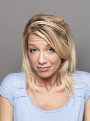 negligence concept - coward young blond woman expressing careless arrogance for mistake,studio shot