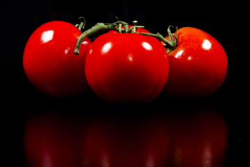 Fresh Vine Ripened Tomato on Dark Background