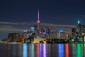 amazing stunning gorgeous beautiful night view of Toronto city downtown from lake Ontario with colorful light reflections in water