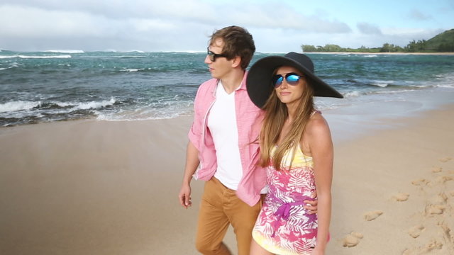 Romantic couple in love holding hands and walking on beautiful summer on hawaiian beach, Oahu, Hawaii, USA.