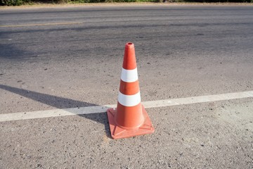 traffic cone on rim the macadamized road - twilight time