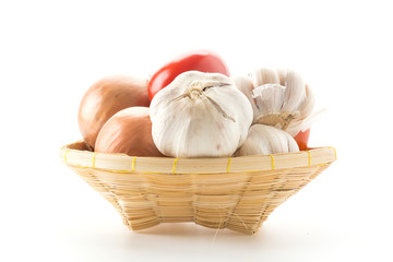 tomatoes, onion and garlic in basket