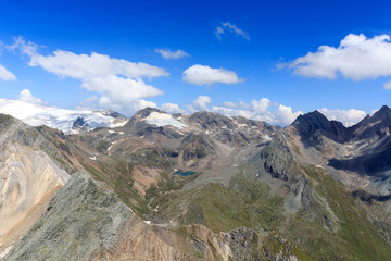 Fototapeta na wymiar Panorama view with lake Eissee, mountain Weißspitze and glacier Großvenediger in the Hohe Tauern Alps, Austria